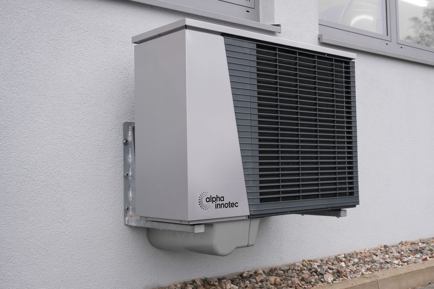 An outdoor residential heat pump mounted beside a home